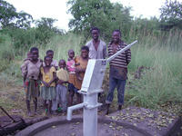 Photo shows The Sisters install bore holes and hand pumps 