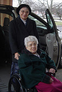 Sister Rose and a woman on a wheel chair picture